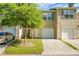 Charming townhome featuring a single-car garage and a well-manicured front lawn with a tree at 250 Grand Oaks Dr, Ladson, SC 29456