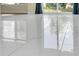 Close up of the polished marble floor reflecting the water and trees outside the sliding glass doors at 250 Grand Oaks Dr, Ladson, SC 29456