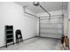 Spacious garage featuring a functional garage door, concrete floor, and storage options at 250 Grand Oaks Dr, Ladson, SC 29456