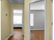 Hallway view showcasing wood flooring and doorways leading to rooms with natural light at 250 Grand Oaks Dr, Ladson, SC 29456