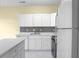 Contemporary kitchen features white cabinets, stainless steel appliances, and sleek countertops at 250 Grand Oaks Dr, Ladson, SC 29456