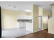 An open living space with an attached modern kitchen featuring white cabinetry and stainless steel appliances at 250 Grand Oaks Dr, Ladson, SC 29456