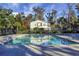 Community pool with trees and a home in the background at 250 Grand Oaks Dr, Ladson, SC 29456