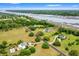 Beautiful aerial view of a large estate with mature landscaping, pool, and river access at 2636 Anchor Watch Dr, Wadmalaw Island, SC 29487