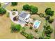 Gorgeous aerial view of an estate featuring a pool, garden, circular driveway, and lush landscaping at 2636 Anchor Watch Dr, Wadmalaw Island, SC 29487