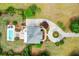 Stunning aerial view of a home with a private pool, circular driveway, and beautifully landscaped grounds at 2636 Anchor Watch Dr, Wadmalaw Island, SC 29487