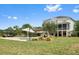 Beautiful backyard with in-ground pool, pergola, covered patio, and lush landscaping at 2636 Anchor Watch Dr, Wadmalaw Island, SC 29487