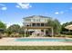Stunning backyard with a pool, pergola-covered lounge area, and ample space for entertaining at 2636 Anchor Watch Dr, Wadmalaw Island, SC 29487