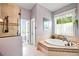 Bright and spacious primary bathroom featuring an alcove soaking tub, glass shower and tiled floor at 2636 Anchor Watch Dr, Wadmalaw Island, SC 29487