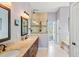 A bright primary bathroom with double vanity, glass enclosed shower and soaking tub with tile surround at 2636 Anchor Watch Dr, Wadmalaw Island, SC 29487
