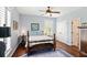Bright bedroom with hardwood floors, and a large window with plantation shutters provides plenty of natural light at 2636 Anchor Watch Dr, Wadmalaw Island, SC 29487