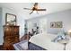 Bright bedroom features hardwood floors, neutral walls, and a large window with plantation shutters at 2636 Anchor Watch Dr, Wadmalaw Island, SC 29487