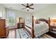 Charming bedroom with shuttered windows, hardwood floors, and a four-poster bed offers a comfortable retreat at 2636 Anchor Watch Dr, Wadmalaw Island, SC 29487