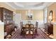 Traditional dining room with a chandelier, wainscoting, and a large wood table at 2636 Anchor Watch Dr, Wadmalaw Island, SC 29487