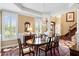 Traditional dining room with hardwood floors, chandelier, large windows with shutters and decorative rug at 2636 Anchor Watch Dr, Wadmalaw Island, SC 29487