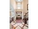 Grand foyer with soaring ceilings, beautiful hardwood floors, and elegant staircase with rod iron spindles at 2636 Anchor Watch Dr, Wadmalaw Island, SC 29487