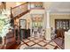 Grand foyer boasts hardwood floors, staircase with wrought iron spindles, and decorative console table at 2636 Anchor Watch Dr, Wadmalaw Island, SC 29487