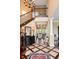 Elegant foyer features hardwood floors, staircase with wrought iron spindles, and decorative console table at 2636 Anchor Watch Dr, Wadmalaw Island, SC 29487