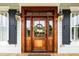 A beautifully crafted wooden front door with glass accents and decorative wreath at 2636 Anchor Watch Dr, Wadmalaw Island, SC 29487