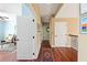Inviting hallway with rich wood floors and a patterned rug offers a warm welcome to the home's interior at 2636 Anchor Watch Dr, Wadmalaw Island, SC 29487