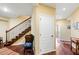 Inviting hallway featuring hardwood floors and stairs with decorative ironwork, exuding classic elegance at 2636 Anchor Watch Dr, Wadmalaw Island, SC 29487