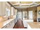 Bright kitchen features a long island with granite counters, white cabinetry, and stainless steel appliances and dark hard wood floors at 2636 Anchor Watch Dr, Wadmalaw Island, SC 29487
