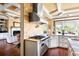 Modern kitchen with stainless steel range hood, tile backsplash, granite countertops, and hardwood floors at 2636 Anchor Watch Dr, Wadmalaw Island, SC 29487