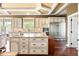 Bright kitchen featuring granite island, custom cabinets, stainless appliances, and hardwood floors at 2636 Anchor Watch Dr, Wadmalaw Island, SC 29487
