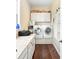 Functional laundry room featuring a washer, dryer, and storage cabinets and laminate wood floors at 2636 Anchor Watch Dr, Wadmalaw Island, SC 29487