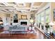 Cozy living room with fireplace, hardwood floors, built-in bookshelves, and sliding glass doors to porch at 2636 Anchor Watch Dr, Wadmalaw Island, SC 29487