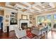 Cozy living room featuring a fireplace, built-in shelves, and coffered ceilings at 2636 Anchor Watch Dr, Wadmalaw Island, SC 29487