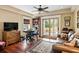 Cozy living room featuring hardwood floors, an area rug, and sliding doors to the outside at 2636 Anchor Watch Dr, Wadmalaw Island, SC 29487
