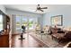 Spacious living room featuring hardwood floors, natural light, and a comfortable seating area with balcony access at 2636 Anchor Watch Dr, Wadmalaw Island, SC 29487