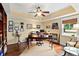 Elegant home office with rich wood floors, tray ceiling, and a well-appointed workspace with ample storage at 2636 Anchor Watch Dr, Wadmalaw Island, SC 29487