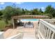 An upper view of a pool featuring an outdoor lounge area covered by a pergola at 2636 Anchor Watch Dr, Wadmalaw Island, SC 29487