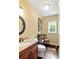 Charming powder room with a decorative mirror and a stylish window, perfect for guests at 2636 Anchor Watch Dr, Wadmalaw Island, SC 29487