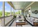 Inviting screened porch with wicker furniture, outdoor views, and a light blue ceiling at 2636 Anchor Watch Dr, Wadmalaw Island, SC 29487