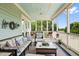 Relaxing screened porch with comfortable seating, ceiling fan, and view of the backyard at 2636 Anchor Watch Dr, Wadmalaw Island, SC 29487