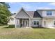 View of the backyard with a screened porch and outdoor seating, perfect for relaxing and entertaining at 281 Jackson St, Goose Creek, SC 29445