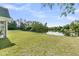 Expansive backyard with green grass, a serene pond, and mature trees creating a relaxing outdoor space at 281 Jackson St, Goose Creek, SC 29445
