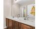 Bright bathroom with double sinks, a large mirror, and wood cabinets at 281 Jackson St, Goose Creek, SC 29445