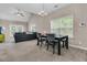 Open-concept dining area flows into the living room, featuring a modern chandelier and lots of natural light at 281 Jackson St, Goose Creek, SC 29445