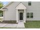 The exterior features a covered entrance and clean lines, showcasing the light gray siding and well-maintained grounds at 281 Jackson St, Goose Creek, SC 29445