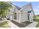 Light gray townhouse featuring a charming architectural design with a covered entrance and an arched window detail at 281 Jackson St, Goose Creek, SC 29445