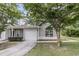 Light gray townhouse featuring an attached garage and classic curb appeal with mature trees at 281 Jackson St, Goose Creek, SC 29445