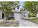 Light gray townhouse featuring an attached garage and classic curb appeal, shaded by mature trees at 281 Jackson St, Goose Creek, SC 29445