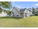 Exterior view of the townhome with a screened in back porch and well maintained backyard at 281 Jackson St, Goose Creek, SC 29445