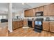 Well-lit kitchen with wood flooring and black appliances at 281 Jackson St, Goose Creek, SC 29445