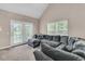 Bright living room showcases a large sectional, big windows and a walk-out patio at 281 Jackson St, Goose Creek, SC 29445