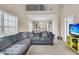 Spacious living room has a large sectional couch and vaulted ceiling that offers a peek at the upper level of the home at 281 Jackson St, Goose Creek, SC 29445